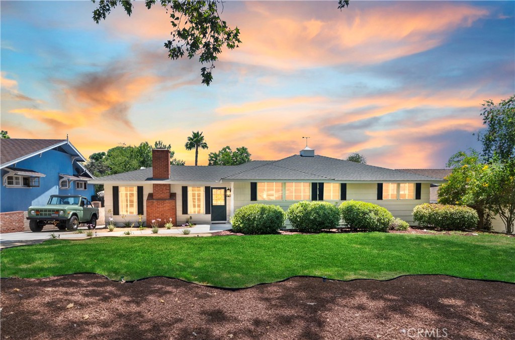 Nestled on a picturesque, tree-lined street at the base of Mount Rubidoux, just minutes from the shops, dining, and entertainment of downtown Riverside, this expertly redesigned 1940s Mid-Century Ranch offers timeless charm with a modern twist. Thoughtfully updated by an interior designer, the home embraces a soothing, monochromatic palette, creating a warm and welcoming atmosphere throughout. Step inside to find engineered oak hardwood floors, recessed lighting, and a serene living room centered around a cozy wood-burning fireplace. Sliding doors open to a peaceful patio—ideal for alfresco dining or morning coffee. The open-concept kitchen is a showstopper, featuring custom white oak cabinetry, a farmhouse sink, open shelving, a coffee bar, Samsung Bespoke black stainless appliances, and Pottery Barn style statement rattan lighting. The main level includes three spacious bedrooms and two beautifully updated bathrooms, along with a generous laundry room. But the true surprise lies below—an expansive 550 sq. ft. finished basement with its own private entrance, recessed lighting, and oak flooring. Perfect for a home office, gym, rec room, creative studio, or multigenerational living—the possibilities are endless. The home features newer roof, re-pipe and central air/HVAC system. And there’s more: the two-car garage includes a private en-suite bedroom and bathroom, ideal for overnight guests, an independent college student, in-laws, or a private office space. With ample parking for an RV, boat, or multiple vehicles outback. Centrally located in one of Riverside’s most beloved neighborhoods, enjoy hikes up Mt Rubidoux and one of the best spots for views of fireworks on the 4th of July. This turnkey home offers comfort, style, and flexibility rarely found at this price point.