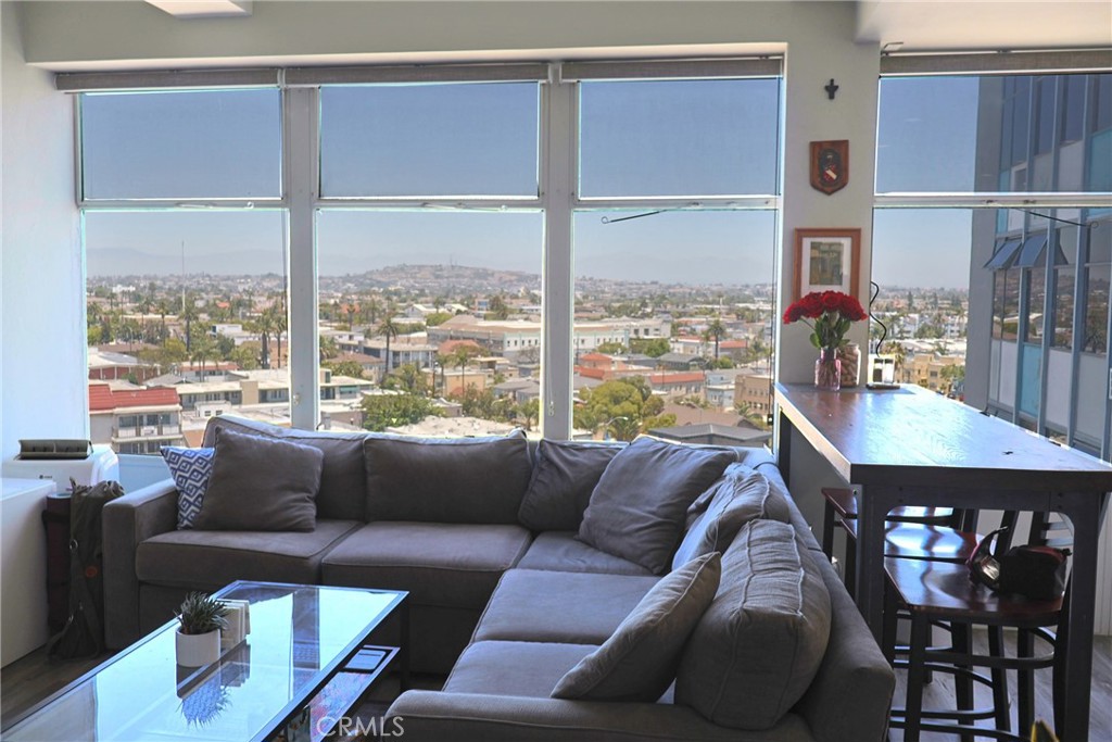 Looking over Long Beach from the 9th floor with Signal Hill in the distance, you can enjoy exciting Long Beach city life and the shoreline beach. This unit is recorded as a studio; however, the bedroom had previously been created with double French doors, and perfected by the current owner without making the unit look squishy. Modern laminate flooring throughout. The remodeled kitchen area will be loved by the new occupant, including a washer/dryer combo machine which is a luxury in any small condominium unit. The floor AC is effective and keeps the unit cool. The Royal Palm’s amenities include a pool, meeting room and garden/BBQ area. The gated entrance provides added peace of mind, and the beautiful lobby with a nice reception has an on-site manager’s office, mailboxes and Amazon lockers. The HOA provides water (hot and cold), trash, pest control and central heating. A car parking space (fee) is assigned in order of the waiting list. Shared storage is available in the parking area.
