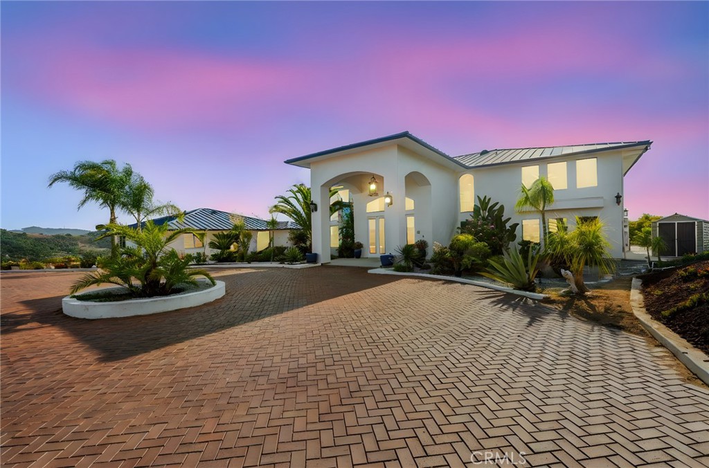Back on the market...huge price adjustment! Opportunity is knocking!! HILLTOP CUSTOM ESTATE with DETACHED GUEST HOUSE1 ~ Stunning 360 Views ~ 6 Bedrooms (4 in main house, 2 in guest house) plus office ~ 5 1/2 Bathrooms ~ Dramatic high ceilings ~ 2 Fireplaces ~ 4 Car tandem style garage ~ EV Charging Station ~ Pre-Paid Solar ~ Newer 50 yr. Metal roof (metal roofs have a Class A fire rating, meaning they resist surface flame spread.) ~ Interior fire sprinkler system ~ Recent RHINO SHIELD Paint interior & exterior ~ 4-zone HVAC System ~ CAT-5 cable wiring ~ Large Deck off the Master bedroom ~ Circular Driveway ~ Grand double door entryway with Foyer and Chandelier ~ Double staircase ~ Blue glass windows ~ Large sized bedrooms ~ Bonus room off master ~ Office downstairs ~ Detached guest home is 1276 sqft, has 1 bedroom, an office (could be 2nd bedroom) sun/craft room, living room and kitchen area with full bathroom, laundry optional hookups and private patio with views. ~ Majestic Bonsall sunset views ~ Add additional homes, or make it your own Compound or consider the business opportunities that await ~ truly an Entertainer's paradise ~ Highly desired Bonsall Schools ~ Located right off of Highway 395 & the 15 freeway ~ Close to Restaurants, Golfing, Wineries, Shopping, Equestrian activities, Hiking & less than 30 mins to the beautiful San Diego Beaches.