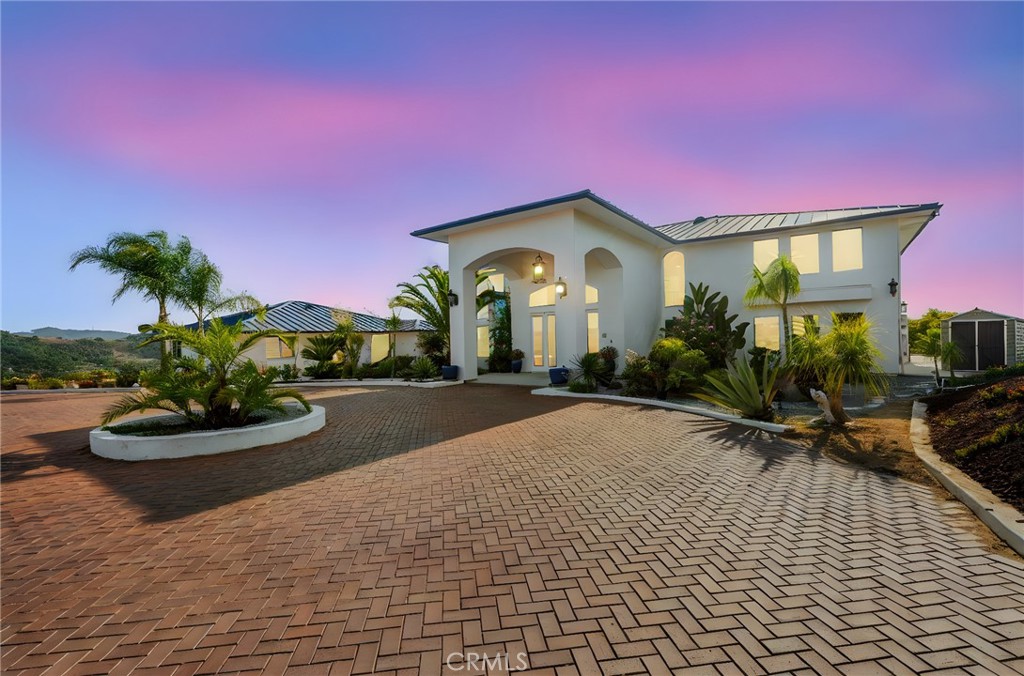 Hilltop Custom Estate with detached Guest House ~ Stunning 360 Views ~ 6 Bedrooms (4 in main house, 2 in guest house) plus office ~ 5 1/2 Bathrooms ~ Dramatic high ceilings ~ 2 Fireplaces ~ 4 Car tandem style garage ~ EV Charging Station ~ Paid Solar ~ Newer 50 yr. Metal roof (metal roofs have a Class A fire rating, meaning they resist surface flame spread.) ~ Interior fire sprinkler system ~ Recent RHINO SHIELD Paint interior & exterior ~ 4-zone HVAC System ~ CAT-5 cable wiring ~ Large Deck off the Master bedroom ~ Circular Driveway ~ Grand double door entryway with Foyer and Chandelier ~ Double staircase ~ Blue glass windows ~ Large sized bedrooms ~ Bonus room off master ~ Office downstairs ~ Detached guest home is 1276 sqft, has 1 bedroom, an office (could be 2nd bedroom) sun/craft room, living room and kitchen area with full bathroom, laundry optional hookups and private patio with views. ~ Majestic Bonsall sunset views ~ Add additional homes, or make it your own Compound or consider the business opportunities that await ~ truly an Entertainer's paradise ~ Highly desired Bonsall Schools ~ Located right off of Highway 395 & the 15 freeway ~ Close to Restaurants, Golfing, Wineries, Shopping, Equestrian activities, Hiking & less than 30 mins to the beautiful San Diego Beaches. **Professional photos coming soon**