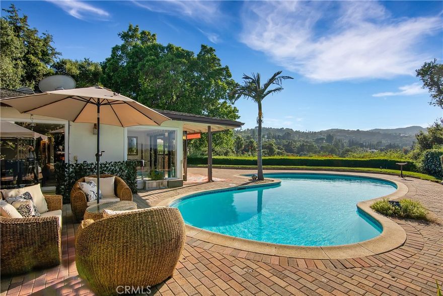 Poolside villa in a tranquil Sherman Oaks  South Ventura Boulevard, featuring a fully renovated main house with 3 bedrooms and 2 baths plus a studio/office with its own separate entrance, a resort-style pool and private basketball court, elevated by seamless indoor–outdoor living, high-end finishes, and thoughtful design, panoramic views and a peaceful neighborhood ambiance, fully furnished for immediate move-in, with convenient access to Sherman Galleria, Brentwood, and Westwood—short-term rental options available.