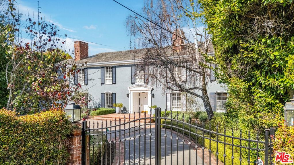Welcome to this beautifully furnished 2-story gated Traditional home, located on one of the most desirable streets in Brentwood Park. Featuring 5 bedrooms and 7 bathrooms, this spacious and elegant property is perfect for comfortable living and entertaining. Inside, you'll find a freshly painted formal living room with a fireplace, a powder room, and a warm and inviting family room with a second fireplace. The great room and family room both open to a serene, private backyard, creating a seamless indoor-outdoor flow. A gourmet kitchen with a center island and breakfast area, spacious dining room, and bar area makes this home ideal for hosting gatherings. Upstairs, the primary suite offers a peaceful retreat with a wood-burning fireplace, separate office space, and a luxurious spa-style bathroom. There are three additional bedrooms on the second floor, each with its own ensuite bathroom. A flexible gym or office space is also located upstairs. (Note: one of the bedrooms is currently styled as a home office, visible in listing photos with colorful wall art behind the desk.) The fifth bedroom and a separate laundry room are located off the kitchen, making this space perfect for a guest room or staff quarters. The idyllic yard with a pool, spa, patios, pond, vine-covered arbors, and beautiful mature landscaping will make you feel as if you were in the English countryside. Owners are looking to lease for a minimum of 24 months. No sign on property. Showings by appointment only with 24-hour notice. Showings on weekdays from 11 am to 4 pm. Check with listing agent about possible weekend showings.