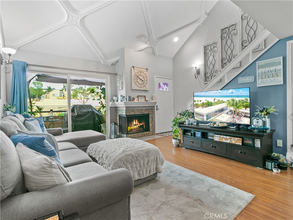 Experience resort-style living in this European villa-inspired condominium featuring a rooftop terrace in Lake Forest. Situated within the desirable Le Parc Community, this well-maintained multi-level unit offers two bedrooms and one bathroom. The main floor presents an open-concept layout, incorporating the living and dining areas adjacent to a spacious kitchen equipped with a breakfast bar. The kitchen is enhanced by refinished cabinetry and new quartz countertops. Additional highlights include a living room with a high-coffered ceiling, access to your main floor balcony, a wood-burning fireplace, and wood laminate flooring. The primary bedroom and bathroom are conveniently located on the main floor. The primary suite features built-in shelving and a walk-in closet. The updated bathroom is appointed with a new vanity and stone countertops. Additionally, there is a dedicated laundry closet with a full-size, stackable washer and dryer. Upstairs, the second bedroom offers a closet, an upgraded ceiling fan, and access to a rooftop terrace. The terrace, complete with a pergola for sun protection, provides stunning views of hills, trees, and the sky—making it ideal for entertaining guests. Further updates throughout the property include new windows, recessed lighting, and crown molding. A spacious two-car garage with a brand-new door is also included. Community amenities feature three pools, spas, landscaped grounds, and a car wash station. This residence is ideally situated near Peachwood Park and the Aliso Creek bikeway trail, and less than a mile from grocery stores, dining, and retail at The Orchard and Foothill Ranch Town Center. Commuters will appreciate easy access to the 405 and 5 freeways, as well as the 241 Toll Road. Welcome Home!