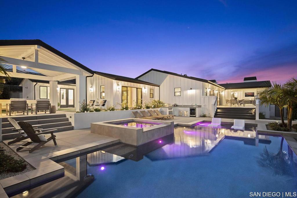 Coastal Dream Home with Sweeping Ocean Views- newly built (2023) , single-level gated estate perched above the coast. With 4 bedroom suites + office, 4.5 baths, and a separate 1 bed/1 bath (800sqft) guest house (ADU), this property blends laid-back luxury with modern design just minutes from the beach, downtown Carlsbad, and top-rated schools. Enjoy panoramic ocean and sunset views from nearly every room matched with a calming ocean breeze. The heart of the home is a glowing Great room with soaring wood-beamed ceilings, a statement fireplace, and wide-open covered patios made for year-round indoor/outdoor living. The chefs kitchen is a showstopper: 48" Wolf gas range, Subzero refrigeration, Miele coffee station, dual dishwashers, wine and beverage coolers, a custom waterfall island, and a secondary butlers kitchen with walk-in pantry. The primary suite is a pure retreat opening directly to the pool and spa with ocean views, and featuring a spa-inspired bath with heated Carrera floors, wet room with soaking tub and dual showers, plus custom his-and-hers walk-in closets. Guest suites open to a peaceful private courtyard with luxe ensuite baths. Step outside and you'll find your own slice of resort living: vanishing edge pool, built-in spa, cabana lounge, BBQ bar, Trex decking, and over (800 sqft) of covered outdoor space perfect for golden hour gatherings. The private guest house is next-level, with ocean views stretching from La Jolla to Catalina, its own kitchen and living space, bedroom opening to a lanai with a summer kitchen, and total privacy. Extras include: 4 fireplac