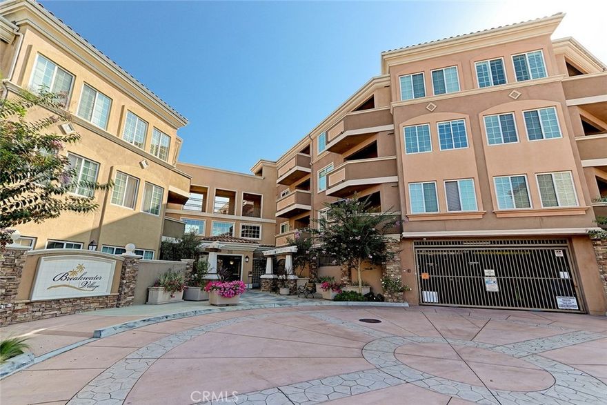 Welcome to Breakwater Village, one of Redondo Beach’s most sought-after 55+ communities. This inviting 2-bedroom, 2-bath condo offers comfort, convenience, and a vibrant lifestyle just moments from the beach.  Step inside to find hardwood floors, granite countertops, and a kitchen with a breakfast bar that opens seamlessly to the bright and spacious living room — perfect for entertaining or relaxing. Each bedroom features its own en-suite bathroom, providing privacy and ease of living. Enjoy the sunshine from your private patio overlooking the beautifully maintained community grounds.  Additional highlights include in-unit laundry, tandem parking for two, and elevator access in this secure, gated building. Breakwater Village offers low HOA dues which include a heated pool, recreation room, movie room, gym, BBQ area and a wonderful sense of community -all within walking distance to shops, restaurants, and everyday conveniences.  Live the South Bay lifestyle you’ve been waiting for — easy, elegant, and just steps from it all.