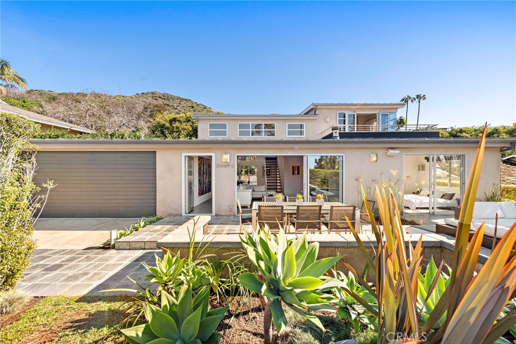 Beautiful contemporary home with ocean views located in one of Laguna's close to the beach neighborhoods. Perfectly situated on a quiet cul-de-sac Marilyn Dr, this gorgeous Tim Nicol's designed residence is an entertainers paradise. Primary bedroom suite situated on the second level with ocean views and a generous attached private deck to take the afternoon sunsets. 3 additional guest bedrooms (one currently being used as a combo media/bedroom) are situated on the ground level offering easy access to the front and back outdoor living areas. Expansive open chefs kitchen, dining and living room are surrounded by walls of glass doors creating seamless transition between nature and dwelling space. Lush tropical foliage surrounds ultra private back yard, large salt water pool and spa, and multiple lounge areas. Private front yard outdoor living space with built in fire pit, dining area. Easy access in minutes to Montage Resort and Spa, and Laguna's finest most sought after restaurants and beaches. A place of peace and tranquility to come live the dream in beautiful Laguna Beach.