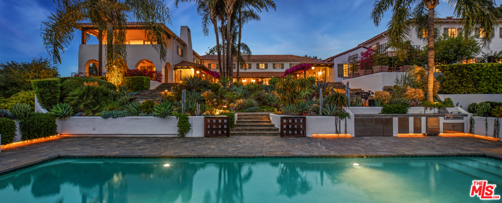 An extraordinary 3.2-acre hilltop estate featuring unobstructed city views spanning downtown LA to the ocean. Legendary history and multiple structures comprise this breathtaking compound completely secluded by gates and lush greenery. Enter the romantic courtyard covered in bougainvillea, revealing a remodeled 1920's Spanish-style hacienda. Featuring 5 bedrooms, a beautiful living room with beamed ceilings, elegant library, family room, gourmet chefs kitchen, gym with massage room, luxurious main bedroom suite with large walk-in closets & limestone bath, professional screening room, separate 2-bedroom guest house and staff quarters. There's a spectacular swimming pool, championship lighted tennis court and incredible outdoor areas for entertaining throughout. Featuring a remarkable and state-of-the-art glass & steel recording studio/guest house/private office structure with its own entrance. Shown to prequalified clients only. (Approximate sf breakdown: 5 bed/4.5 bath main residence is 9,584 sf, cinema building is 1,877 sf, 2 bed/2.5 bath guest house is 1,759 sf, 2 bed/2 bath staff quarters is 1,080 sf, 1 bed/3.5 bath recording studio is 9,163 sf.)
