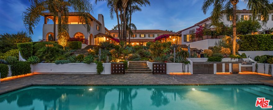 An extraordinary 3.2-acre hilltop estate featuring unobstructed city views spanning downtown LA to the ocean. Legendary history and multiple structures comprise this breathtaking compound completely secluded by gates and lush greenery. Enter the romantic courtyard covered in bougainvillea, revealing a remodeled 1920's Spanish-style hacienda. Featuring 5 bedrooms, a beautiful living room with beamed ceilings, elegant library, family room, gourmet chefs kitchen, gym with massage room, luxurious main bedroom suite with large walk-in closets & limestone bath, professional screening room, separate 2-bedroom guest house and staff quarters. There's a spectacular swimming pool, championship lighted tennis court and incredible outdoor areas for entertaining throughout. Featuring a remarkable and state-of-the-art glass & steel recording studio/guest house/private office structure with its own entrance. Shown to prequalified clients only.  (Approximate sf breakdown: 5 bed/4.5 bath main residence is 9,584 sf, cinema building is 1,877 sf, 2 bed/2.5 bath guest house is 1,759 sf, 2 bed/2 bath staff quarters is 1,080 sf, 1 bed/3.5 bath recording studio is 9,163 sf.)
