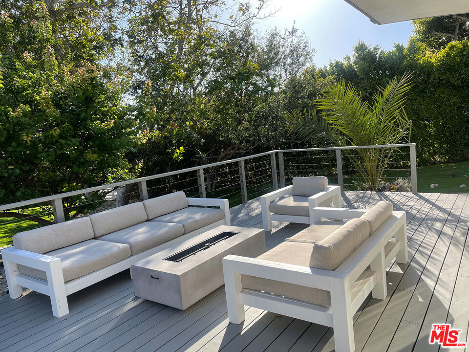 Best deal in Malibu Park! Available 6/1/2025. No need to sit in traffic Malibu High is a five min walk from home. This contemporary estate is over half an acre, all flat, set on two parcels with separate APN numbers 4469-043-020 and 4469-043-019. This home offers the ultimate indoor/outdoor living experience. A huge side yard patio perfect for BBQs and entertaining along with two large private decks make this home an entertainer's dream. Enjoy the privacy of nearly 20ft tall ficus trees enclosing the entire property that includes a secure, fenced in back yard for dogs. Two car garage with additional parking and entry gate. 10 min walk to Zuma beach. 5 min walk to Malibu High. Generac generator installed and connected to gas line so it auto switches on no need to do anything if power goes out. Dogs and cats welcome. Price is for 1 year unfurnished lease. There is a Guest house on the property that is being used for storage, it can be made available to potential tenants for additional cost. Guest house not included in listing price.