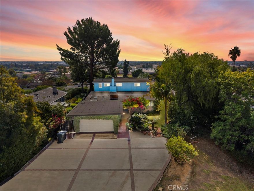 VIEW! VIEW! VIEW! This home has STUNNING PANORAMIC VIEWS and is tucked away on the hilltop in the highly desirable Hillcrest Park neighborhood in Fullerton.  This home features a bright and open floorplan with 3 bedrooms, 2.5 bathrooms with 2,025 square feet of spacious living space on a 13,901 square foot lot. Upon entering, you are greeted by the living room which has plenty of natural lighting Cozy brick fireplace and is adjacent to the dining room. The beautifully designed kitchen includes plenty of cabinetry for storage, electric cooktop, countertop seating, skylights for natural lighting and is open to family room. The main floor also features a TWO DOWNSTAIRS SPACIOUS BEDROOMS, full sized bathroom with updated tub/shower combo.  The upstairs showcases a spacious Primary Suite with private retreat that includes a spacious bedroom, large balcony WITH PANORAMIC VIEWS retreat area with cozy brick fireplace and dry bar. The primary bathroom features a glass enclosed shower and updated sink vanity.  The Private backyard is beautifully designed with covered patio area, mature landscaping, scenic views, fountain and large side yard for entertaining. Additional features of the home include 2 car garage with extended driveway for additional parking, and laundry in garage.  Centrally located close to Fullerton College, walking distance to Hillcrest Park and the Fullerton Trail which has miles of scenic paths for hiking and biking. Only a short distance to dining, shopping and entertainment. Com view this beautiful house and make it yours today!