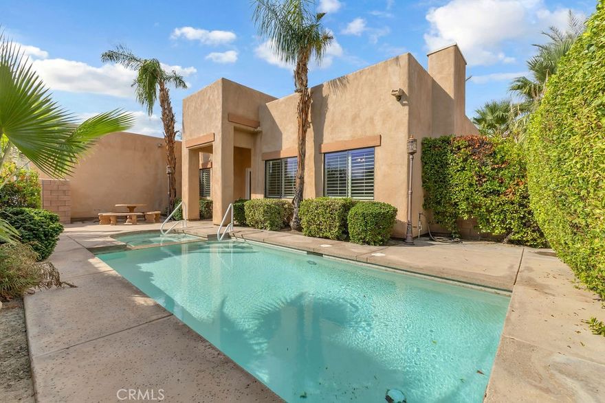 Welcome to Serenity Cove, a fully gated, hidden gem of a community on the edge of Rancho Mirage in Cathedral City. This beautifully maintained 3-bedroom, 2-bath home offers 2,207 sq. ft. of stylish desert living. Enter through a gated courtyard into your private retreat with a front-loaded saltwater pool and spa, complete with a picnic table for outdoor dining. Inside, the open layout features custom wood built-ins, including a banquet with overhead storage, and large-format tile flooring throughout. The primary suite opens to the patio through a sliding glass door and includes a walk-in shower with a bench and a spa tub. One of the guest rooms doubles as an office with a built-in desk, storage, and a Murphy bed for added flexibility. Energy efficiency shines with high-performance solar panels providing low-cost utility bills. Outdoors, enjoy a private backyard with sitting area, fruit trees, and garden prep space. Close to everything the Coachella Valley has to offer, Serenity Cove offers privacy, convenience, and spacious living.