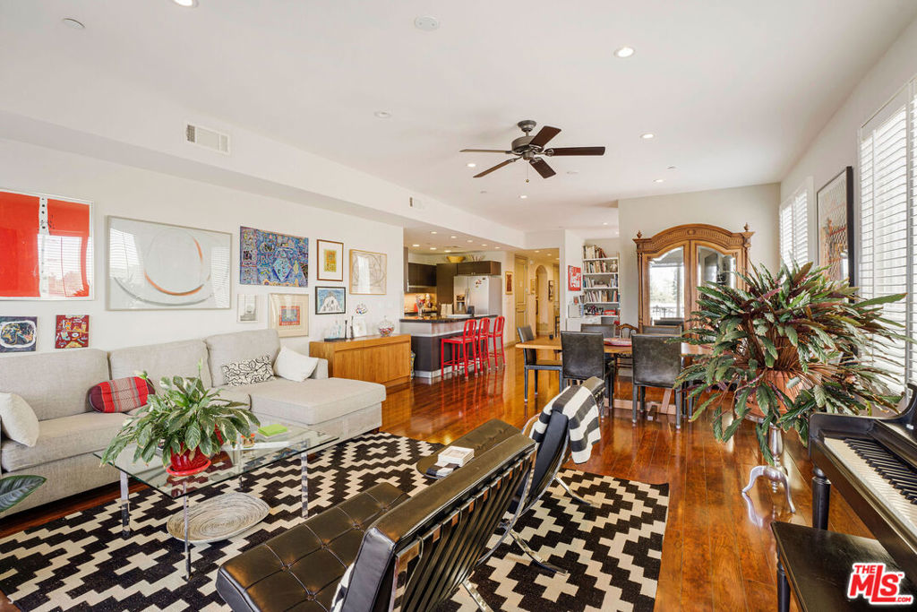 Stylish and sophisticated, this 2-bedroom, 3-bath New York style flat offers a refined living experience in the desirable Westside Village neighborhood. With expansive city views spectacular by day and sparkling at night this residence combines modern design with comfort and convenience. A gracious foyer introduces the streamlined floor plan, featuring a gourmet kitchen with abundant cabinetry, breakfast nook, and adjacent dining area. The versatile den/office flows seamlessly into the great room, where modern fireplace, and floor-to-ceiling windows create a bright and open atmosphere. Glass sliders from both the living area and primary suite lead to a large balcony with treetop and city vistas.The spacious primary suite includes an oversized walk-in closet and a spa-like bath with dual sinks, soaking tub, and separate shower. Additional highlights include a full second bath, a powder room, a true laundry/utility room with side-by-side washer and dryer, and generous storage throughout. Natural light streams in from southern, western, and northern exposures.Secure gated garage with tandem parking. Community offers close proximity to UCLA Research Park, Westwood Greenway, Century City, Westfield Century City Mall, and vibrant shopping and dining along Westwood and Pico Blvd. Clover Avenue Elementary School district.A sophisticated lifestyle opportunity awaits!