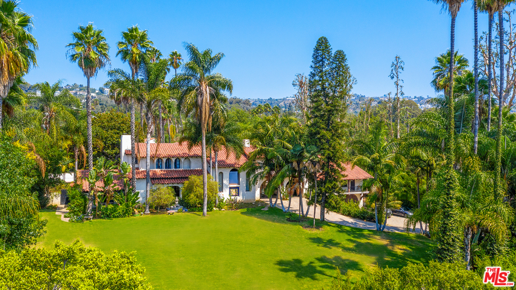 Stately and Iconic 1920s Spanish Estate prominently perched on a knoll in the heart of Beverly Hills. Enter through gates on either Sunset Boulevard or Mountain Drive to this extraordinary 1.14 acre setting of park-like grounds, epic lawn, extensive gardens and mature trees. Wonderful opportunity to restore and renovate the existing 5-bedroom, 4.5-bathroom authentic Spanish Revival home rich in character and period details, including tile floors, stunning ironwork, stenciled beams and ceilings, period fixtures and mosaic fountains. Grand entry off the porte-cochere with elegant sweeping staircase and expansive living room with French doors accessing the beautiful rear courtyard, with fountain, pool and gardens. Long stone paver driveway off Mountain Drive leads through the porte-cochere to 2-bedroom plus living room guest quarters, 4-car garage and motor court. Ideal entertaining home with old world Hollywood appeal. A rare offering.