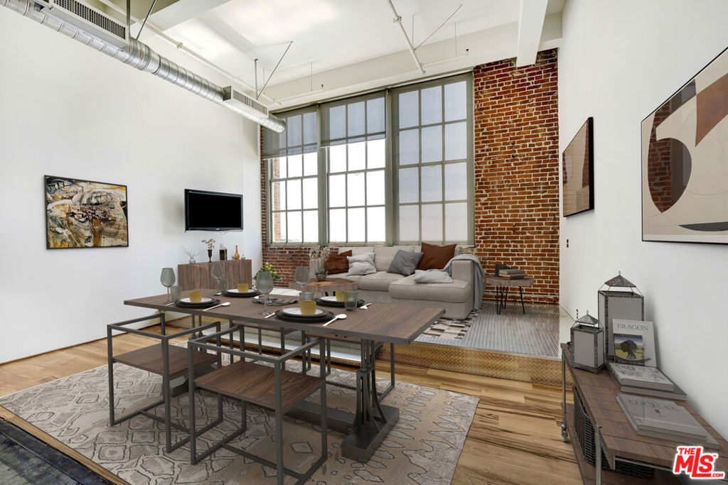 Live above it all in this exceptional top-floor unit at the historic Biscuit Company Lofts in the heart of DTLA's Arts District. Soaring 16ft ceilings, skyline views, and a thoughtfully added enclosed room and mezzanine loft offer the ideal balance of character and versatility, perfect for a creative studio, work-from-home setup, or guest space.This Mills Act-approved building means significant property tax savings, making ownership even more rewarding. Enjoy access to premium amenities including a resort-style pool, outdoor lounge with fire pit and BBQ, dog walk, and a state-of-the-art gym located just across the street at the Toy Factory Lofts. One dedicated parking space is included.Step outside and explore the best of the neighborhood. Walk to popular restaurants, cafes, breweries, and the exclusive SOHO Warehouse. This is a rare opportunity to own a piece of LA history with modern perks and unbeatable location.