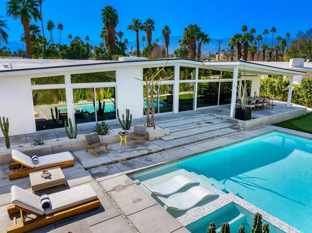 73286 Goldflower Street is a stunning mid-century modern gem by renowned architect Charles Du Bois, once the private retreat of Hollywood legend James Franciscus. Featured on the 2025 Modernism Week Signature Home tour, this meticulously restored and expanded residence blends its iconic heritage with modern luxury. Nestled on a quiet cul-de-sac near El Paseo, this fully furnished home offers the ultimate in south Palm Desert living.A multi-year renovation, completed in 2024, expanded the home to over 3,000 sq. ft., including a seamless 1,000 sq. ft. addition. Du Bois's signature indoor-outdoor flow is enhanced with expansive glass walls, clean architectural lines, and abundant natural light, perfectly capturing California Modernism. High-end finishes, warm walnut accents, and sleek modern tile work elevate the interiors, while smart home technology integrates effortlessly. Every detail, from the restoration of original elements to the selection of contemporary materials, has been carefully curated to honor the home's historic significance while offering today's most desirable comforts.The oversized primary suite is a private retreat with a zen garden, outdoor shower, walk-in closet, and built-in gym. An additional en suite guest room offers privacy, while two guest bedrooms share a spacious bath, making it ideal for hosting. A dedicated laundry area adds everyday convenience.Designed for relaxation and entertainment, the open-plan living space includes a great room with a pool table, multi-room Sonos speakers, and Phillips Hue lighting, all controlled by voice, phone, or wall-mounted panels.The entertainer's backyard features a covered lounge, built in heaters, fire pit, and multiple courtyards, maximizing indoor-outdoor living. Thoughtful landscaping and architectural details create a harmonious retreat.This architectural masterpiece in south Palm Desert presents a rare opportunity to own a piece of history close to El Paseo, shopping and everything you may need.
