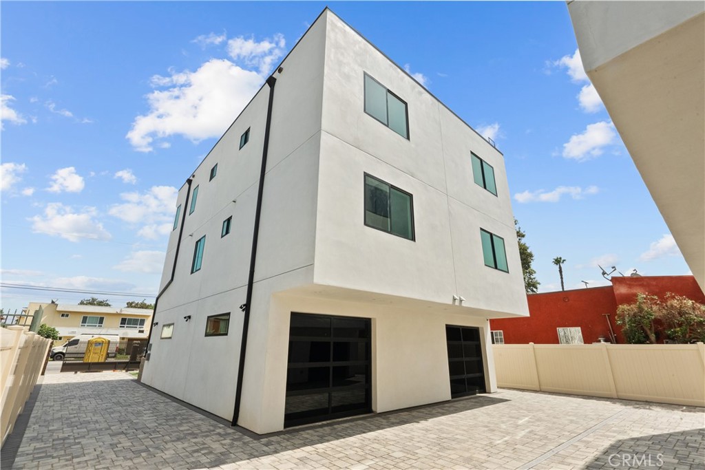 This newly built rear unit at 13944 1/2 Vanowen St in Van Nuys offers modern design and everyday comfort. The home has three bedrooms and two and a half bathrooms, spread out over a smart layout. It totals about 2,468 sq ft, including a private two-car garage and a laundry area with direct access to a private patio. The interior space, excluding the garage, is approximately 1,801 sq ft, ensuring a comfortable and private living environment. On the main level, you will find a bright open-concept living area that connects to a private balcony, ideal for relaxing or entertaining. Upstairs, the three bedrooms are located together, including a spacious primary suite. The living room also opens to a separate balcony, creating several outdoor areas and a smooth indoor-outdoor living experience. This home features high-quality finishes, lots of natural light, and a quiet location at the back of the property. It provides a rare chance to live in a modern, private, and peaceful setting. The home is also conveniently close to Valley Glen, major freeways, and everyday services, making it a great choice in the San Fernando Valley.