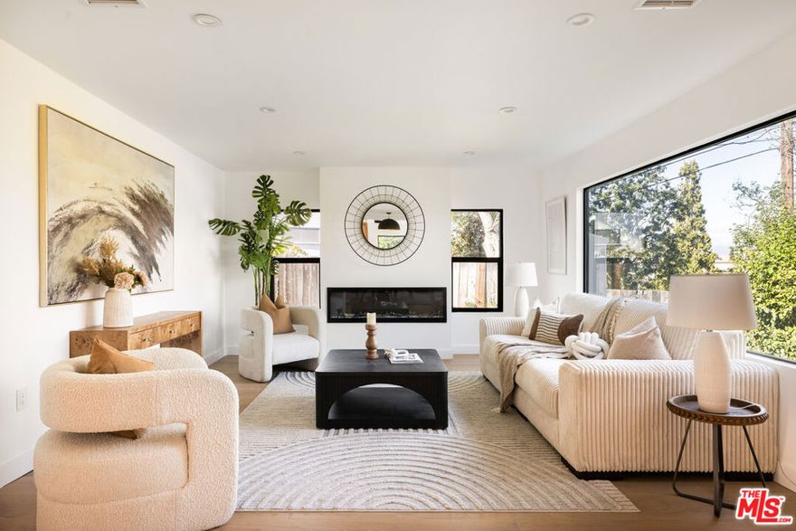 Welcome to VIBELAND, Studio City- where everyone finally gets their own bathroom! This newly reimagined, design-forward retreat south of the Boulevard delivers modern luxury, effortless functionality, and true move-in readiness. Reimagined for today's luxe lifestyle, this approx. 2,470 sq ft home offers 5 en-suite bedrooms and 5.5 baths on an approx. 7,628 sq ft lot. Designed for space, flexibility, and real life, the home features two primary suites (one up, one down), each with oversized walk-in showers and soaking tubs - choose your retreat based on your mood.  Wide-plank white oak floors and an open, sun-filled layout set the tone for elevated daily living. The chef's kitchen boasts a large eat-in island, high-end appliances, quartz counters, wine fridge, and custom cabinetry, all flowing into stylish dining and living spaces anchored by a modern fireplace.  Expansive sliders open to a generous covered deck and newly landscaped yard perfect for al fresco dinners, weekend lounging, and indoor-outdoor California living. Fair warning: people will invite themselves over. A sleek set of LED-lit stairs leads you to the upper-level bedrooms and terrace where you'll find a bonus living area with vistas sweeping the valley, Universal Studios, and mountains, ideal for WFH, fitness, music, or gaming. And when July rolls around, enjoy front-row seats to Universal's iconic fireworks. Two more en-suite bedrooms flank the flex landing space. A two-car garage and oversized driveway offer abundant parking for you and your guests. Located in one of Studio City's most coveted pockets, you're moments from Ventura Blvd hot spots, Fryman Canyon trailheads, the 101, and major studios including Universal, Warner Bros, Disney, and Radford. Welcome home to VIBELAND.