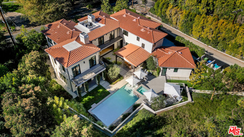 Impeccably designed and maintained Spanish Modern Estate located in the sought-after Rancho Estates, South of Ventura Boulevard in Encino. Built in 2020, this 6 bed/9 bath property truly defines modern luxury and comfort, featuring a fantastic open floor plan for entertaining, flawless indoor/outdoor flow, and incredible privacy. On the main floor you will find a large chef's kitchen, butler's pantry, large living room, den, and second bedroom currently utilized as an office. The backyard features lush mature landscaping, a stunning pool and spa, plus custom covered patio with kitchen, dining, and built in heating offering a true backyard oasis. The attached garage has plenty of storage, as well as a long, gated driveway with two gates for convenient entry and exit. Upstairs there are 3 generous sized en-suite bedrooms plus a great primary suite with vaulted ceilings, massive walk-in closet, and spa-like bathroom. A rare lower level features a custom-built theater, gym, and additional living space currently utilized as the ultimate playroom! This unique property is built to the very highest standards complete with custom drapery, complete smart home audio visual system, comprehensive security, and every bit of luxury you could imagine...perfect for even the most discerning buyer!