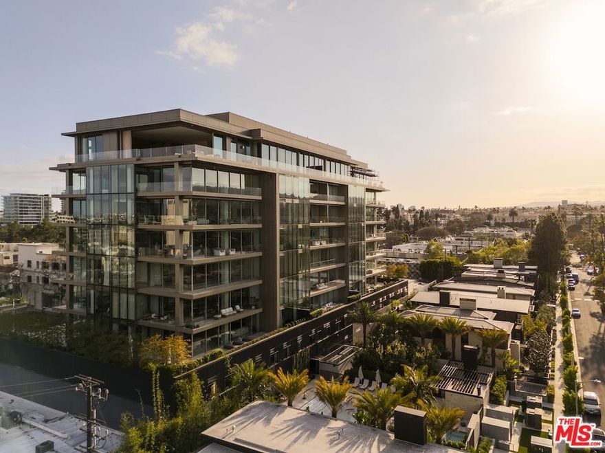Ascend to Penthouse East at 8899 Beverly, an elite living experience in vibrant West Hollywood. Set atop the tallest residential building in the area, this palatial contemporary retreat blends privacy, convenience, and next-level luxury. Spanning 6,451 square feet across a single level plus a 1,550-square-foot wraparound terrace this four-bedroom, four-and-a-half bath penthouse was designed by the globally renowned, award-winning architectural firm Olson Kundig and offers unobstructed, up-close views of the Hollywood Hills, surrounding skyline and mountains beyond. Designed with discretion and convenience in mind, Penthouse East is equipped with a semi-private elevator (which opens directly from the dedicated lower-level valet area) and a separate service entrance and corridor for staff. Arrive to Penthouse East and find 14-foot ceilings, gallery walls and expansive windows that invite daylong natural light and frame breathtaking city views. Floor-to-ceiling motorized glass walls encircle the property and can be opened with the push of a button. The sense of space is both airy and commanding, ensuring every corner of this home feels equally peaceful and indulgent. Full-height wood paneling in the penthouse's great room adds a sense of grandeur, while the expansive outdoor terrace is poised for unforgettable open-air gatherings both intimate and large-scale. An inviting lounge centers around a cozy, ambiance-enhancing fireplace, and the chic chef's kitchen is replete with Gaggenau, Miele and Sub-Zero appliances and Dornbracht fixtures as well as a butler's pantry. An adjacent prep kitchen provides additional space to accommodate bigger get-togethers.