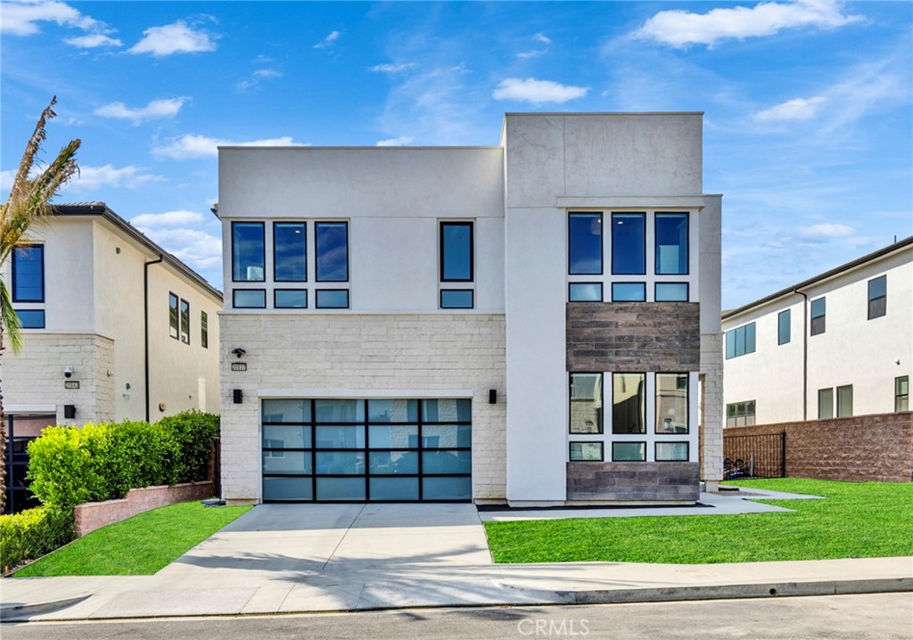 Welcome to this luxurious 5-bedroom, 5.5-bathroom modern residence nestled on the summit of Porter Ranch’s guard-gated Hillcrest community. Built by Toll Brothers in 2022, this expansive 4,000 sqft home offers sleek design, functional elegance, and premium interior upgrades throughout — over $200,000 spent in builder upgrades. Step inside through the two-story foyer featuring modern floating stairs with glass railings, leading into an open-concept living space bathed in natural light. The living room features soaring ceilings and a 3-panel sliding door that fully opens to the patio—perfect for seamless indoor-outdoor living. The gourmet kitchen is a true centerpiece, showcasing an oversized waterfall island, custom quartz countertops and backsplash, and a full suite of top-of-the-line Wolf and Sub-Zero appliances. Upstairs, the loft overlooks the main level through a glass wall, creating a light-filled connection between spaces. The expansive primary suite is large enough to accommodate a private sitting area, and has a large private deck perfect for morning sun or evening breeze. The spa-style master bathroom has dual vanities, soaking tub, and large walk-in closet. There is one en-suite bedroom on the first floor; upstairs offers three more bedrooms (two en-suites, one with adjacent full bath). Flooring were all upgraded with builder, with premium wide porcelain tile throughout 1st floor, and oak wood flooring upstairs. Builder designer finishes include custom bathrooms countertops, shower tiles, framed mirrors, windows and lightings throughout the home. Set on an 8,471 sqft lot, the spacious backyard is ready for your dream outdoor setup. Current backyard is turf only; the photo shown landscaping design concept was prepared by a professional designer. Broker and broker's agents do not represent or guarantee accuracy of the square footage, bedroom / bathroom count, lot size, and/or any other information concerning the conditions or features of the property. Buyer/Tenant is advised to independently verify the accuracy of all information through personal inspection & with appropriate professionals to satisfy themselves.