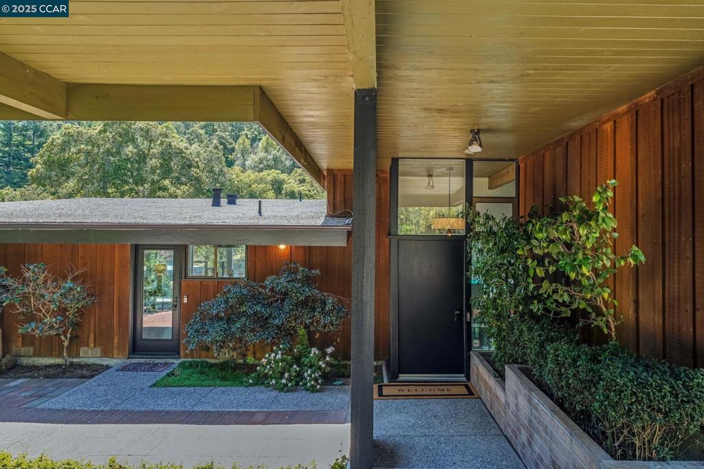 Step into this beautifully updated mid-century modern home, where floor-to-ceiling windows flood the space with natural light and vaulted wood-beam ceilings add warmth and character. Expansive living room and dining area. Enjoy effortless flow into the open-concept kitchen and family room, featuring a sleek, modern kitchen with extensive cabinetry, a large island with smooth stone countertops, and SS appliances. Sliding doors lead directly to the breathtaking backyard that shows like a peaceful, private oasis with an expansive deck, inviting pool, and lush lawn surrounded by mature flowering trees and shrubs. The spacious primary suite is a true retreat, with floor-to-ceiling windows, sliding door access to the serene backyard, a large walk-in closet, and a beautifully updated bathroom. A split-level layout offers added privacy with two additional bedrooms, a generously sized laundry room, and an updated bathroom featuring an oversized shower. Recently painted throughout and refinished hardwood floors. Bonus room for at home office space. Close to downtown, freeway access and BART.