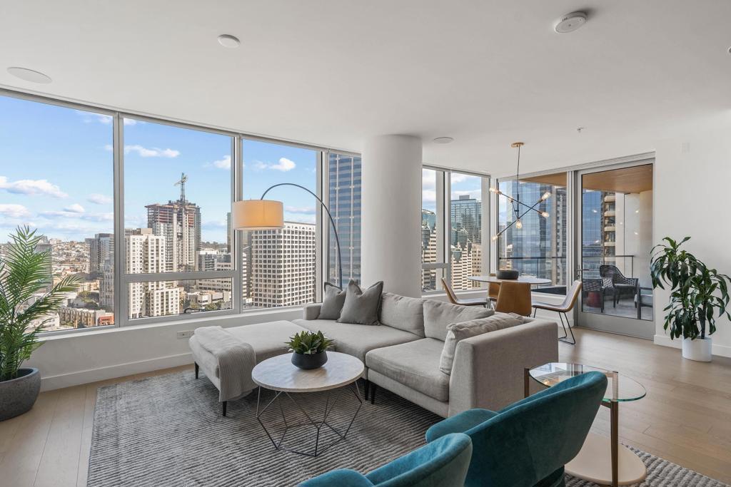 Experience luxury high-rise living at Pacific Gate on the iconic Downtown San Diego Waterfront district. Perched on the 22nd floor, this light-filled 2 bed, 2 bath, 1,390 square foot residence offers dazzling city lights and sparkling bay views—high enough to clear the Intercontinental Hotel while capturing the charm of the historic Santa Fe Depot. The open-concept layout is enhanced by custom upgrades, including a sleek modern entertainment center in the living room and a spacious walk-in closet in the primary suite. The desirable split-bedroom floor plan provides privacy, while expansive windows frame the stunning vistas. Enjoy San Diego’s mild climate from your private covered terrace, perfect for morning coffee or evening sunsets. Pacific Gate residents indulge in resort-style amenities such as a private yacht share, luxury car fleet, 24/7 concierge, guest suite, resident’s lounge, a state-of-the-art fitness center with sauna and steam room, on-site celebrity chef restaurant, and much more! This is the perfect blend of luxury, comfort, and world-class convenience. The first all-glass Super Prime residential tower in San Diego offers an unprecedented waterfront lifestyle with sky-high amenities and picture-postcard views. Directly overlooking the waterfront, the 41-story tower contains an exclusive offering of homes designed by Hirsch Bedner Associates. Renowned New York-based architectural firm Kohn Pedersen Fox (KPF) created a landmark that reimaged the San Diego skyline. The custom-engineered glass walls dynamically reflect the hues of the sky and the Pacific Ocean. Pacific Gate has evolved the San Diego skyline and represents the future of the city. The building is comprised of two-nested curved glass towers that rise as a single column from a three-story ground floor retail podium on the north and west sides of the tower. Because of the building’s curves and exterior glass, Pacific Gate offers a striking viewing experience from every vantage point. Residents arrive home to a beautifully landscaped motor court with a private luxury car fleet, which leads to a double-height lobby with a 24-hour concierge and porter services. Two levels of amenities boast a residents lounge ideal for events and everyday use, the fitness center contains an extensive range of state-of-the-art equipment. Adjacent to the fitness center is the steam and sauna retreats that open up to the fourth-floor pool terrace fitted with poolside cabanas and glass surround.