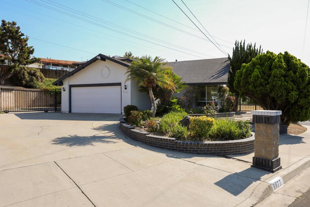Rare opportunity in Casa De Oro! This amazing home is full of character and unique features, perched privately at the top of the street with sweeping views of the mountains. Ideal for a large or extended family, nice open floorplan. The entire upper level is dedicated to a luxurious primary suite featuring an oversized Jacuzzi tub, custom glass block and tile shower with a skylight, wraparound marble dual-sink vanity with a large window, a separate toilet room, and a huge walk-in closet. A private balcony offers serene views of Mt. Helix, and a second skylight brings in even more natural light. Downstairs includes three additional bedrooms and two full bathrooms. The spacious family room impresses with vaulted ceilings, a wood-burning fireplace, and floor-to-ceiling built-in bookshelves. The open-concept kitchen features tile flooring, a gas cooktop... ...and plenty of room to gather and cook. There's also a dedicated laundry room with sink and storage, plus a built-in desk area perfect for an office. With six skylights and recessed lighting throughout, the home feels bright and airy. Outside, the masonry walls, walkways, and wrought iron fencing add elegance and privacy. A large exterior space offers potential for a custom outdoor kitchen, fireplace, spa, or even RV storage!