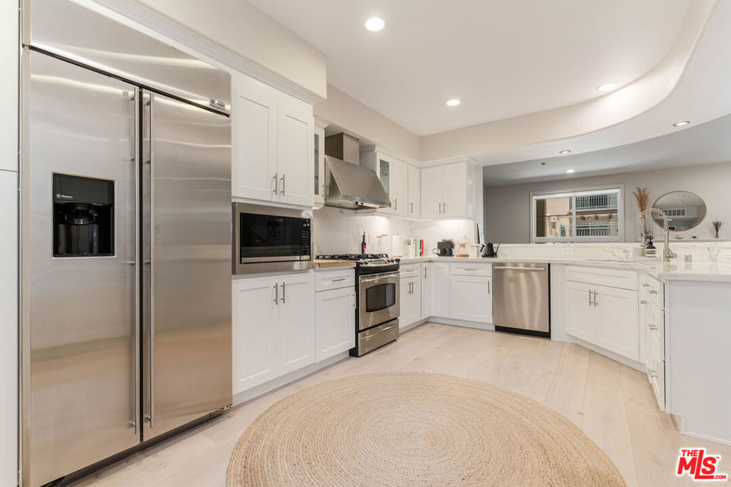 Discover elevated Playa Vista living in this beautifully updated Serenade home, ideally located just moments from Concert Park, Runway, and the community's top amenities. Freshly renovated with stunning upgrades throughout, this home offers both style and function in a serene, private setting. Step inside to an open-concept great room featuring all-new light wood flooring, fresh paint, and large windows. The reimagined kitchen is a standout, complete with sleek quartz countertops, soft-close shaker cabinetry, under-cabinet lighting, and top-quality appliances, including a Bosch dishwasher and Frigidaire microwave. Bar seating connects the kitchen to the dining area and adjacent patio- perfect for entertaining or everyday living. The living room includes automatic shades and a cozy fireplace, and the updated powder room is conveniently located on the same floor. Upstairs, you'll find two ensuite bedrooms, including a spacious primary suite with a private balcony, a walk-in closet with custom built-ins, and a beautifully appointed bath. A second bedroom with its own upgraded closet and full bath, along with a dedicated laundry area, completes the upper level. Additional features include new HVAC systems with Ecobee thermostats on both floors, a front door keypad entry, a built-in security system, and ample storage. Two separate parking spots offer convenient access to a community EV charger. Located just across the street from Concert Park and the surrounding shops and restaurants. Enjoy the best of Playa Vista living with close proximity to the Centerpointe Club, The Resort, Runway's retail and dining, Whole Foods, Cinemark, Playa Vista Elementary School, and all the amenities that make this Silicon Beach community so special.