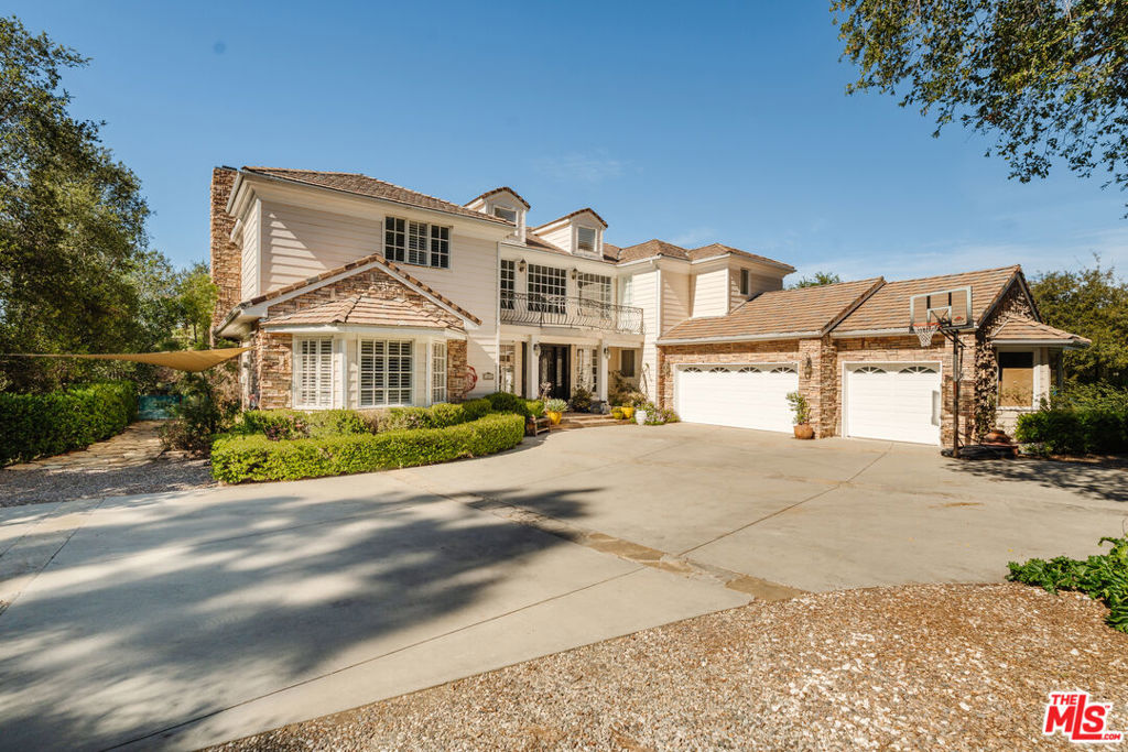 Tucked away at the end of a long private driveway, in the exclusive gated community of Braewood, this nearly two-acre estate presents a rare opportunity to reimagine luxury living. Originally designed by the community's developer for his own family, the home boasts a thoughtful floor plan, stunning natural surroundings, and timeless architectural details ready for your personal touch. As you step inside, you are greeted by a grand two-story foyer, where soaring windows flood the space with natural light, perfect for showcasing art or making a dramatic statement. A sweeping spiral staircase draws you upstairs to three spacious bedroom suites, a large office and a landing with panoramic views. Throughout the home, character-rich features like custom fireplaces, French doors, and rich wood accents provide an ambiance of comfort and style. The family room, with its Ralph Lauren-inspired aesthetic, opens directly to the backyard, creating effortless indoor-outdoor flow. A formal living room and dining room each offer refined spaces for entertaining, both opening to enchanting gardens draped in wisteria, perfect for dining al fresco under the stars. The chef's kitchen is built for culinary inspiration, complete with granite countertops, a walk-in pantry, a large center island, and premium appliances. It flows into a sunny breakfast room overlooking the lush grounds, inviting you to enjoy morning coffee surrounded by nature.Downstairs, two additional bedroom suites offer flexibility for guests, family, or creative spaces. Upstairs, the primary suite is your personal retreat featuring generous square footage, abundant light, a private office or sitting area with a fireplace, and a balcony overlooking the storybook-like setting below. The spa-inspired primary bathroom includes dual vanities, an oversized shower, soaking tub, and dual walk-in closets. Step outside, and you'll discover what truly sets this property apart: expansive lawns, mature landscaping, and multiple areas for relaxing, entertaining, or simply enjoying the peace and quiet. Whether you're dreaming of a pool, guest house, or garden oasis, there's room to bring your vision to life. A long private driveway leads to a spacious three-car garage, offering both convenience and privacy in a home designed for comfort, style, and effortless entertaining. Located in the coveted Las Virgenes Unified School District and just minutes from Calabasas' top shopping, dining, and Westside access, this is more than a home it's a rare opportunity to create something truly special.