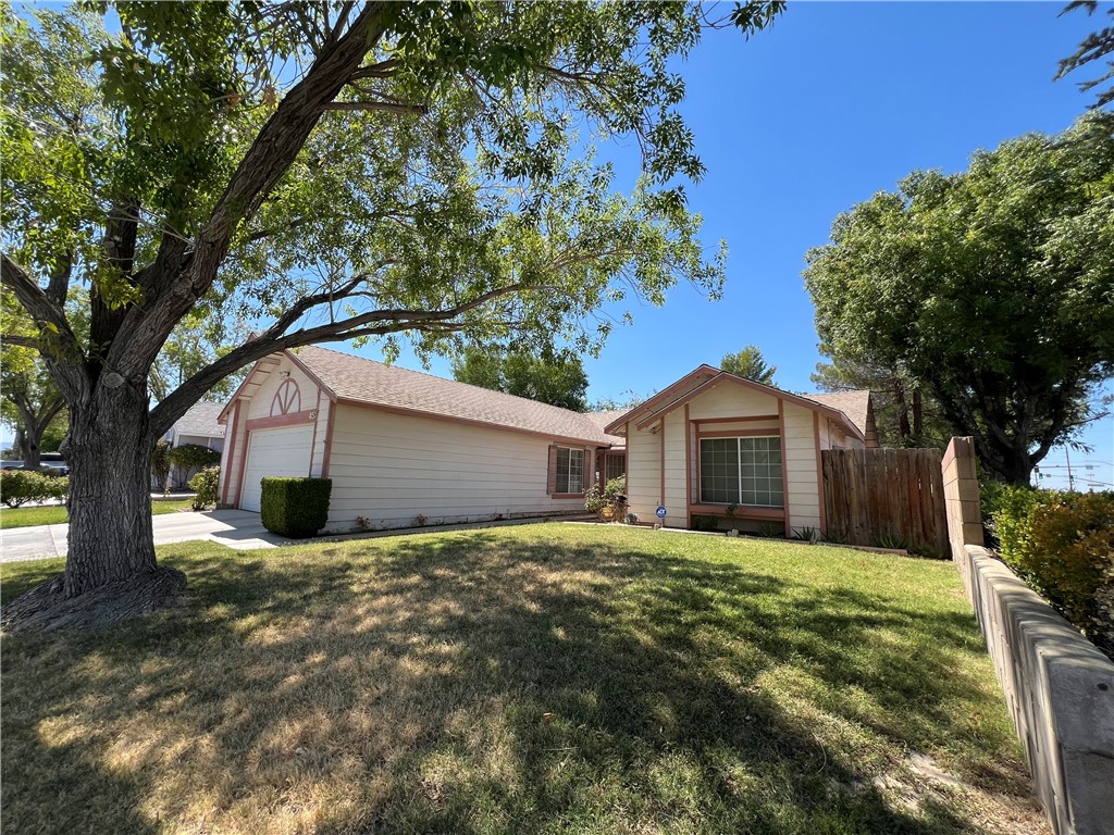 This home is perfect for a growing family. The home features 4 bedrooms and 2 full bathrooms, A bright updated kitchen with granite counter tops, stainless steel appliances and dinning area. The living room features faulted ceilings, a fireplace, dinning room and sliding patio doors that lead out to the nice size backyard. The home also has solar panels that will help run the air conditioner and 2 swamp coolers. The side yard is large enough to park an RV or a boat. Centrally located next to shopping, parks and the freeway. Be the first to make an offer this home is priced to sell FAST!