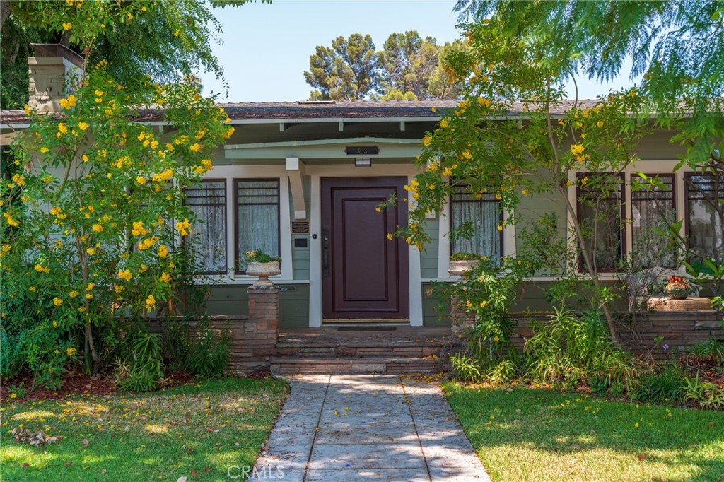 Own a Piece of Anaheim History: The Judge Homer Ames House (Circa 1911) – Mills Act Approved/ Program Participant!
Step into a timeless masterpiece at 303 N. Philadelphia Street – the distinguished Judge Homer Ames House. This unique, single-level Craftsman Bungalow boasts captivating Japanese-influenced architecture, characterized by its sprawling, low-pitched roofline and inviting open flagstone porch, all gracefully perched on a gentle sloping corner lot.
Beyond its breathtaking aesthetics, this home offers an extraordinary financial advantage: it's a Mills Act property, providing significantly reduced annual property taxes of just $3,371! Adding to its prestige, it's also proudly listed on the National Register of Historic Places and is a cherished part of the historic Melrose Backs Neighborhood within the Anaheim Colony historic district.
Built in 1911 by Judge Homer Ames just before he became Anaheim's esteemed City Attorney (1912-1925) and later a Superior Court Judge, this residence exudes history. Inside, a large, rectangular living room welcomes you with a classic fireplace and elegant French doors leading to a versatile office/den. The formal dining room is a true highlight, featuring exquisite pocket doors, a built-in buffet, and unique wainscoting design. Throughout the living spaces, large casement windows invite beautiful natural light and offer picturesque views of charming Washington Park.
The kitchen has been thoughtfully remodeled, offering plentiful crisp white cabinets, abundant counter space, and a convenient walk-in pantry. The remodeled bathroom is a triumph of design, seamlessly blending modern functionality with period-appropriate aesthetics.
Additional features include a BONUS room which can be a home office or a third bedroom, an oversized one-car garage with a dedicated workshop and laundry area, a small basement, a tankless water heater, central air and heat, newer roof, and two generously sized bedrooms.
Enjoy an unbeatable location just blocks away from the vibrant Center Street Promenade, the renowned Anaheim Packing District, and a myriad of downtown amenities. This is more than a home; it's a living legacy.