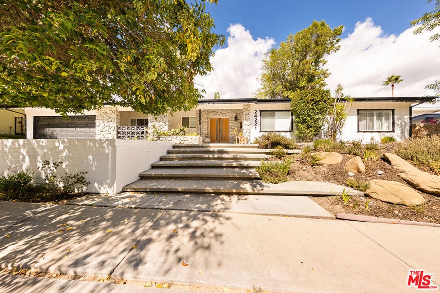 Designed by renowned architect Charles DuBois, this 1964 Mid-Century Modern masterpiece embodies timeless California living. Featuring 3 bedrooms, 2.5 baths, a two-car garage, and 2,401 sq. ft. of refined interiors on a 10,898 sq. ft. lot, the home showcases DuBois's signature open-beam ceilings, rich wood floors, and a wraparound dual fireplace at its center. Enhanced in 2022, it seamlessly blends architectural heritage with modern luxury. The flowing layout connects a grand living area, formal dining room, and chef's kitchen with a spacious island. French doors open to a private, resort-style backyard oasis with a pool, gazebo, and sport court, surrounded by lush landscaping. Perfect for both grand entertaining and quiet retreat. Located within the top-rated Woodland Hills school district, this residence is a legacy of design, reimagined for those who value elegance, comfort, and distinction. Ready to be lived in, cherished, and called home.