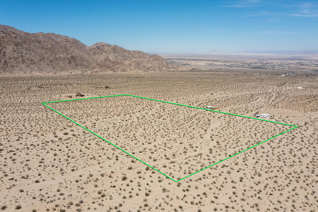 Owner may carry! Panoramic 20 acres adjacent to the JTNM Park gate in the desirable Upper Hanson Area of 29 Palms. Tranquility with breathtaking vistas high above 29 Palms. Magical sunset & city lights. Very few neighbors. 20 acres offers opportunities to build a designer compound with several homes and guest homes. Potential for subdividing to optimize your investment. No water but power is in the street. Beautiful natural fauna. Nestled in a valley between the Little San Bernardino Mtns & the Twentynine Palms Mtns. About 2500ft elevation. Beyond the city of 29 lay the vast Bullion Mtns. Close to all amenities in 29 Palms. Short drive to Tortoise Rock Casino, the 29 Palms Inn, the new Freedom Mall, cafes, organic restaurants, bars & boutiques. About 3 million tourists visit the JT National Monument annually. 29 is becoming a boom town with tourism & desert beauty enthusiasts with new designer homes, new hotels & new businesses springing up around town. Home designers & architects have been building & remodeling many homes with trendy mid century modern styles. So much opportunity with such a large parcel. Many consider the Upper Hanson Area to become the next hottest neighborhood to boast million dollar homes. Priced to sell! For all questions on building & uses contact the city planners. For all questions on utilities contact them directly. APN 059105113 Address is not a real address & for marketing purposes only. Dirt road, 4x4 recommended. GPS: 34.091836 -116.030002
