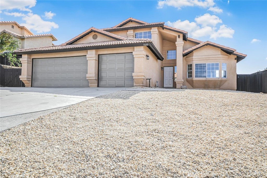 This beautifully renovated home is move-in ready and offers fresh curb appeal with brand-new trim paint on the exterior and a completely repainted interior that brings a clean, modern feel throughout. Step into a bright and stylish kitchen featuring freshly painted cabinets with new hardware, gleaming granite countertops, a new stainless steel appliance suite, and an upgraded faucet—perfectly complemented by the adjacent breakfast nook and formal dining area. The home boasts brand-new vinyl plank flooring downstairs and plush new carpet in all the bedrooms, enhancing the warmth and comfort of every living space. Enjoy two spacious living areas, a convenient downstairs bedroom and full bath, and a thoughtfully updated Jack & Jill bathroom upstairs with a new vanity, counter, faucet, lighting, and toilet. The luxurious master suite is your private retreat, complete with a dual vanity, new counters and under-mount sinks, updated faucets, a separate soaking tub and shower, and a large walk-in closet. The front yard features fresh new rock landscaping, while the backyard is built for entertaining with custom concrete, two covered sitting areas, and a built-in BBQ. A rare feature of this property is the oversized 3-car garage with special doors that allow walk-through access without raising the door, and a full pass-through into the backyard—ideal for extra parking or recreational use. Centrally heated and cooled, this home is located in a desirable neighborhood near schools, shopping, and dining. This is a rare offering—don't miss your chance to tour this exceptional home today!