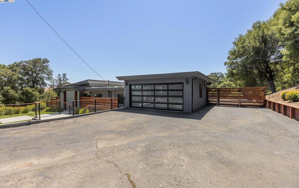 Experience elevated living in this stunning, fully rebuilt modern home on Danville’s coveted Westside. Located in the exclusive Sky Terrace community, this rare 1.4+ acre property offers panoramic views of Mount Diablo and seamless indoor-outdoor living through La Cantina doors that open to a spacious deck. The open-concept floor plan features high-end modern finishes throughout, including wide-plank hardwood flooring, marble tile bathrooms, sleek Euro-style cabinetry, and natural Quartzite countertops with a waterfall island and glass-beveled backsplash. A chef’s kitchen showcases top-tier appliances, including a premium Sub-Zero refrigerator, 48" professional cooktop with griddle, smart double ovens, and a built-in drawer microwave. The primary suite offers breathtaking views and direct access to the deck. One of the four bedrooms has been transformed into a custom walk-in closet by Valet Cabinets, perfect for a fashion-forward lifestyle. All bedrooms, including the luxurious primary suite, are conveniently located off a single hallway for ideal flow and functionality. Step outside to a fully hardscaped backyard oasis complete with an infinity-edge pool, custom outdoor furnishings from Terra (most included in sale), and multiple gathering spaces designed for both !