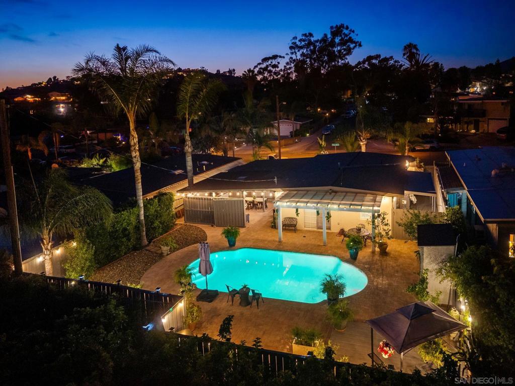 First time on the market in nearly 30 years! This lovingly maintained 3-bed, 2-bath home has been filled with unforgettable memories and is ready for its next chapter. While the interior offers a thoughtfully updated 1,008 sq ft, the true magic lies in the incredible outdoor living space. Step outside to your private backyard oasis.. featuring a refreshing pool, extended deck, shaded pergola, and an expansive covered entertainment area complete with a refrigerator, TV, ceiling fans, storage, and custom countertops. Whether it’s game day, summer BBQs, or quiet evenings under the lights, this space was made for year-round enjoyment. Low-maintenance pavers stretch from the carport through the yard, framed by dozens of mature palms and ambient evening lighting. Inside, enjoy shutters throughout, recessed lighting, a soaking tub in the shared bath, and a walk-in shower in the primary ensuite. Located just one block from Maryland Elementary and 2 minutes to the 8 freeway via Lake Murray Blvd, this gem blends charm, comfort, and unbeatable lifestyle.