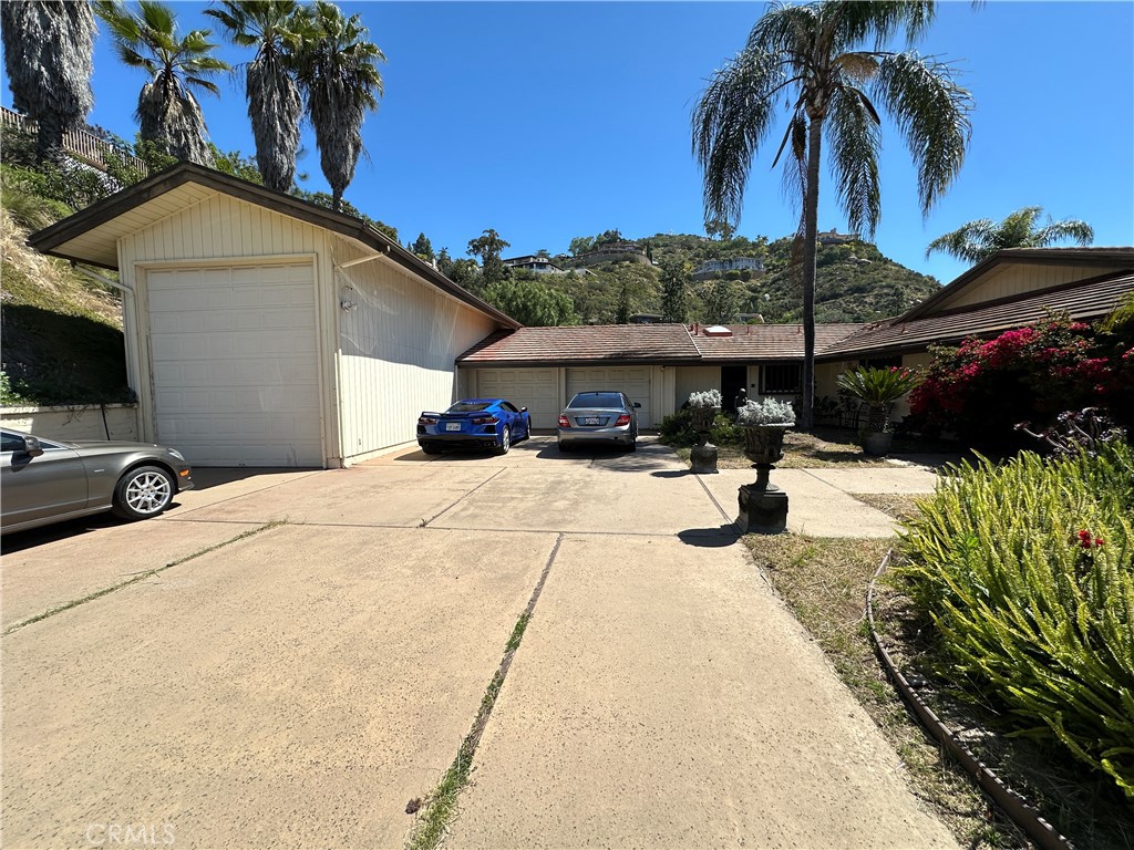 SELLER WILL CARRY with 20 percent down at a 2 percent interest rate. Welcome to Grandview Estates in Mount Helix, where privacy, space, and panoramic views come together in this 4,600+ sq ft hillside home. Situated at the end of a private shared driveway with its own gated entrance, this property offers peace and seclusion in one of La Mesa’s most sought-after neighborhoods. The home features two generously sized decks — one on each level — perfect for taking in the sweeping mountain and canyon views. The spacious primary suite includes a sliding glass door that opens directly onto the upper deck, creating the perfect spot to enjoy your morning coffee or unwind at sunset. Inside the primary suite, you’ll find a bathroom and walk-in closet that rival the size of a bedroom, complete with a massive walk-in shower. With two bedrooms upstairs and two downstairs, the home offers flexibility for a variety of living arrangements. The upper level lives like a true single-story home, with everything you need — kitchen, living room, primary suite, and guest room — all on one level. Downstairs, a second full kitchen, living space, and two additional bedrooms make it an ideal setup for multi-generational living or even two separate households. And if space is what you need, this property delivers — with parking for over 10 cars behind the gate, a two-car garage, and an oversized RV garage. Whether you need room for guests, a home business, or your favorite toys, you’ll find it here. This is more than a home — it’s a rare opportunity to enjoy the best of Mount Helix living with space, privacy, and endless possibilities.