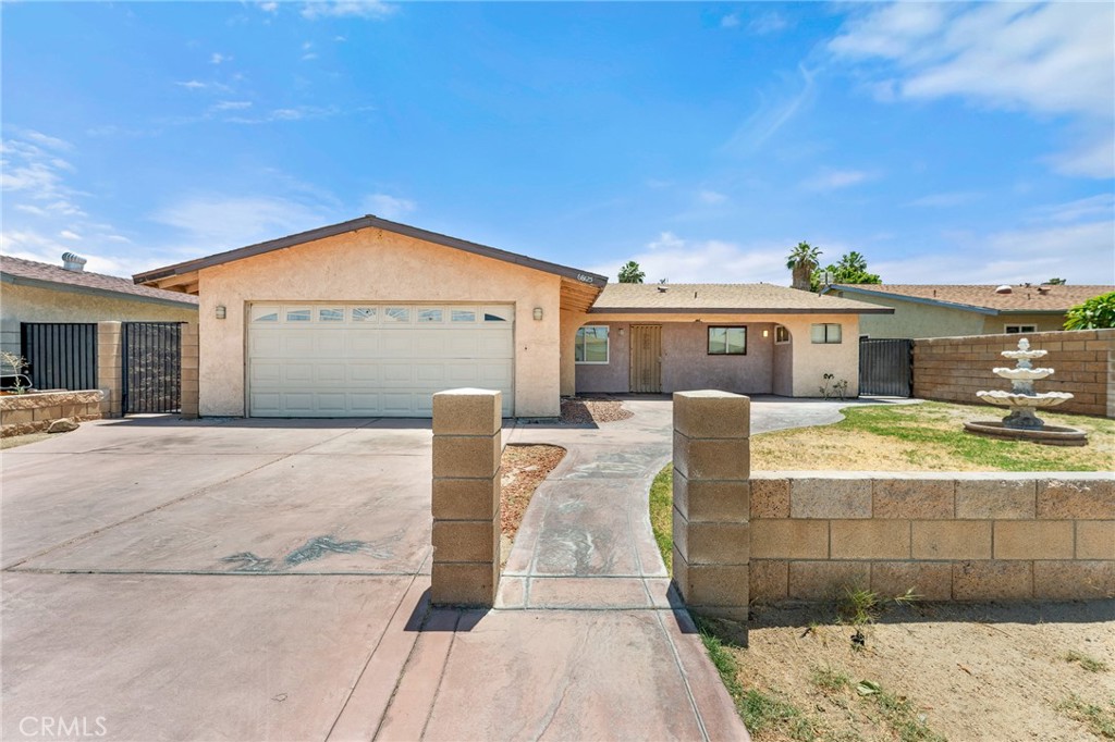 Wonderful opportunity to own! Move in ready - 3 bedroom, 2 bath home in the Panorama neighborhood of Cathedral City! Upon entering you are greeted by the spacious open-concept living area and the updated kitchen with stylish finishes + breakfast bar. The living room complete with cozy fireplace and french doors is perfect for unwinding or entertaining guests. The primary bedroom features extra closet space and full bathroom with an updated shower. Additional bedrooms are generously sized. Attached 2 car garage has ample room for all your storage needs. Located on a large gated lot surrounded by mountain views. Near schools, parks, shopping, and dining. This home is ready for new owners to make it their own!