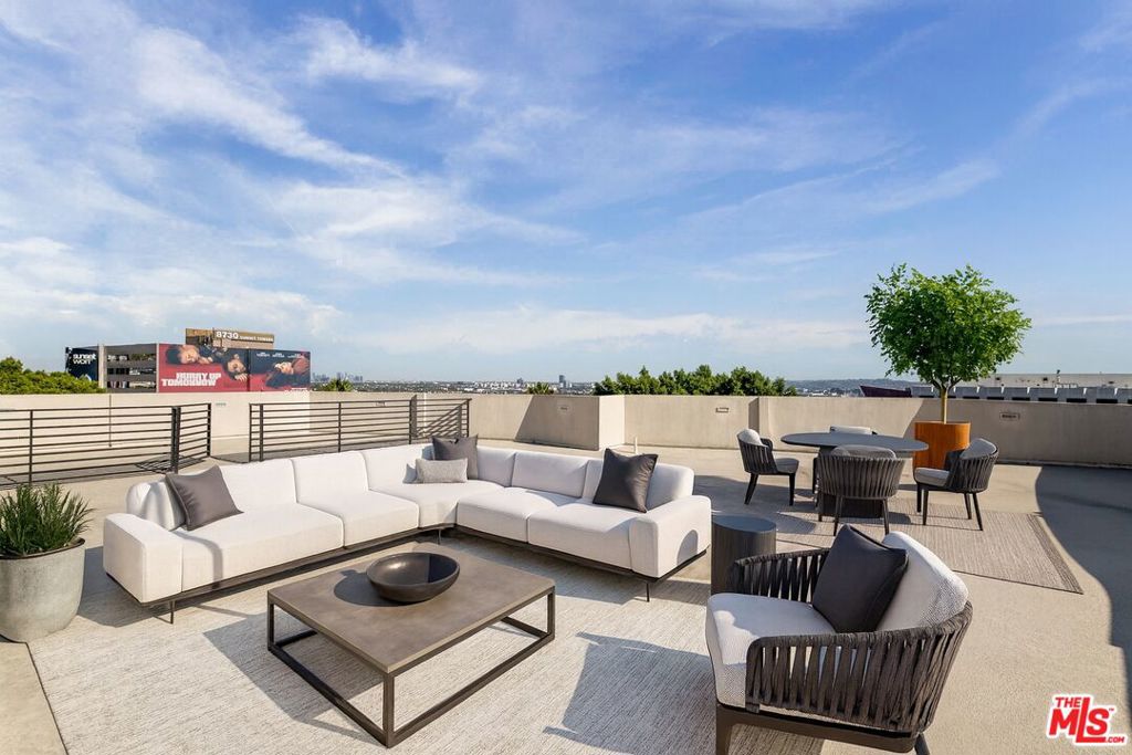 Located in the heart of West Hollywood, at the doorstep of the Sunset Strip, this penthouse delivers privacy, security, and sweeping 360-degree views from its 1,600 sq. ft. rooftop deck. West-facing for the best sunsets, the two-bedroom, two-bathroom residence has been recently updated. Flooded with natural light, the living and dining areas connect directly to a large balcony through floor-to-ceiling glass doors. The kitchen is equipped with ample storage, quartz countertops, Viking stainless steel appliances, and a clean modern design. The primary suite is positioned on the southwest corner of the building and is adorned with a marble-tiled shower, soaking tub, and a spacious walk-in closet. Additional amenities include a private balcony with direct views of the Sunset Strip and city skyline, two side-by-side parking spaces, a storage room, secured gated entry with code access, and low HOA dues. Ideal for members of Soho House, San Vicente Bungalows, and The Bird Streets Club. Conveniently situated moments from the world-class dining and shopping that only Beverly Hills and West Hollywood have to offer.