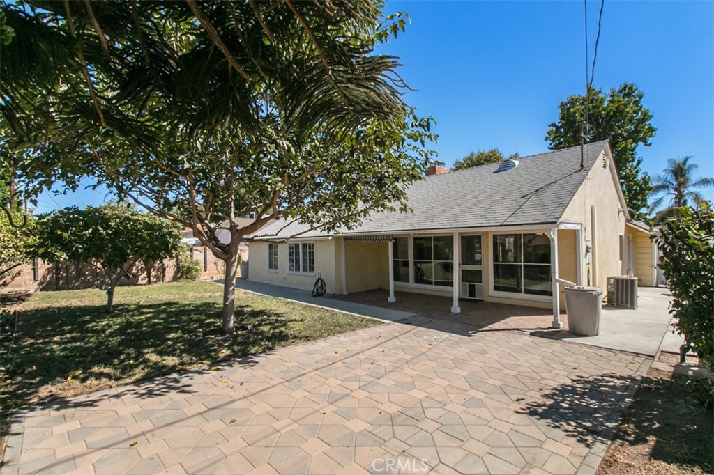 Welcome to this incredibly charming and inviting warm home upgraded with contemporary style and detail. This one-story open floor plan offers 3 bedrooms and 1 spacious bathroom with separate tub and shower. The living room offers a floor to ceiling fireplace with custom mantle, built-in cabinets and an adjoining dining area. It features a wall of oversized windows to enjoy lots of natural light and a lovely view of the serene backyard with a covered porch, large patio & grassy play areas and fruit trees. Enjoy cooking and entertaining in an absolutely gorgeous kitchen with newer cabinetry, granite counters, custom backsplash, sitting bar, premium hardware & lighting. Other amenities include recessed lighting & crown molding, tank-less water heater, copper plumbing, newer roof & A/C unit.