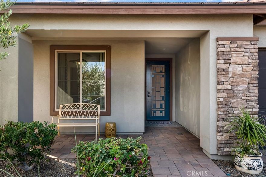 Welcome to this beautifully upgraded single-story home in Trilogy at The Polo Club. Offering 1,847 sq. ft., it features two private primary suites, each with its own large walk-in closet outfitted with built-in cabinetry, plus a third enclosed room ideal for guests or a home office, and a half bath. The café-style kitchen includes two convection ovens, a built-in microwave, quartz counters, upgraded cabinetry, stainless steel appliances, and a generous island. Tile flooring and 9’ ceilings enhance the open layout. A beautiful glass door opens to a landscaped backyard with a covered patio, automatic custom blinds for privacy and shade, and a Jacuzzi, creating a comfortable space for relaxing or entertaining. An air-conditioned garage and paver driveway add convenience and curb appeal. Optional membership provides access to resort-style amenities including pools, fitness center, pickleball, tennis, and June Hill’s Table. Set against the Santa Rosa Mountains, this home blends style, comfort, and an active lifestyle.