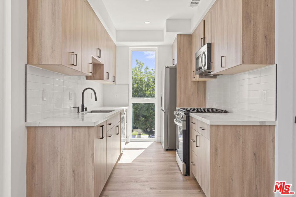 Experience upscale living in this newer construction, tri-level townhome located in the heart of the NoHo Arts District. Enjoy a private entrance into a sleek, modern unit flooded with natural light from sliding glass doors, floor to ceiling windows and multiple balconies. The open-concept living area connects seamlessly to a fully equipped galley kitchen featuring stainless steel appliances, quartz countertops, and contemporary finishes. Additional highlights include central air and heat, in-unit laundry and a massive tandem 2 car garage. Just steps away from shops, restaurants, grocery stores, and everything NoHo has to offer.