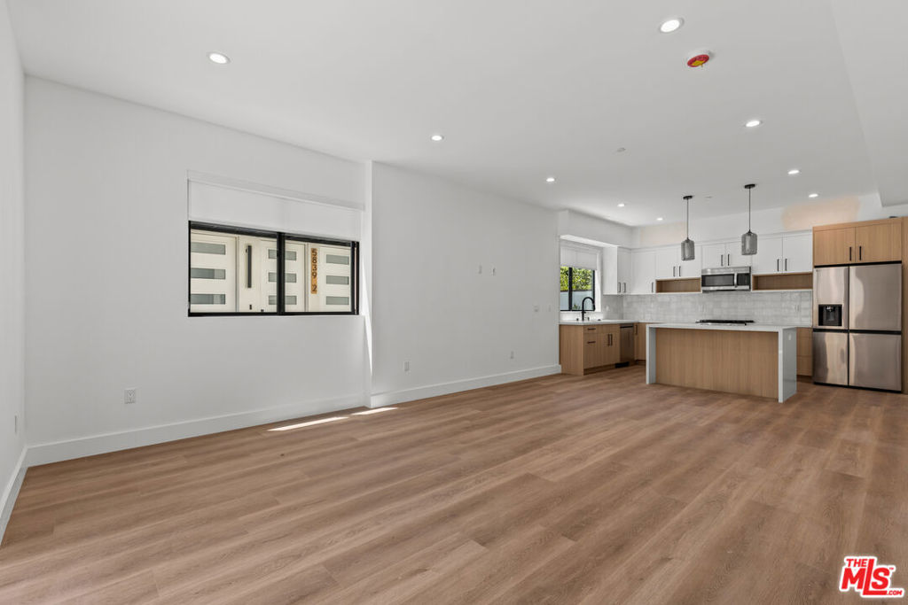 Experience modern luxury in this brand new 4-bedroom, 4.5-bathroom townhome. Every bedroom features its own en-suite bathroom, providing the ultimate comfort and privacy, plus an additional powder room for guests. The spacious open-concept living area is ideal for entertaining, seamlessly flowing into a sleek chef's kitchen equipped with a large island, quartz countertops, and high-end stainless steel appliances. Floor-to-ceiling windows in two of the bedrooms fill the space with natural light, while the other two bedrooms enjoy private balconies. This thoughtfully designed home includes ample storage throughout, including an extra closet on the top floor. Enjoy breathtaking city and mountain views from your expansive private rooftop deck,an ideal retreat for entertaining or unwinding. Located just minutes from popular shops, restaurants, and everything Sherman Oaks has to offer, this home combines contemporary design with unbeatable convenience.
