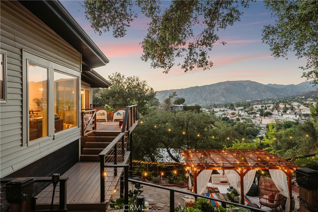 Perched above the valley in Tujunga, this home feels less like a residence and more like a sanctuary. A place where the air is cleaner, the light softer, and the views stretch endlessly — the San Fernando Valley unfolding below, the San Gabriel Mountains rising above, framing your life in nature’s architecture.
Inside, walls of glass open the living and dining spaces to the sky, bathing every gathering in natural light. It’s a space designed as much for morning coffee rituals as for evening conversations — where hospitality feels effortless and beauty is ever-present.
The multi-level backyard echoes the rhythm of a hillside garden: terraces for meditation or yoga at sunrise, shaded alcoves for quiet reading, and expansive decks for family gatherings that last long into the night. Each level tells its own story, but all of them share one truth — a seamless connection to the landscape.
The interiors honor their mid-century heritage with walls of glass that frame sweeping valley vistas, while refined updates bring a sense of ease and modernity — a quartz-wrapped chef’s kitchen anchors the heart of the home, soaring ceilings invite openness, and a newly designed bedroom retreat with a spa-like en suite bath elevates everyday living.
A guest suite below for visiting family, a studio for creativity, or a sanctuary for extended living. It’s a home that evolves with you, supporting both community and solitude. Solar panels are fully paid off, providing the buyer with added value through ongoing energy savings and an environmentally conscious lifestyle.
Set across more than a quarter acre, this residence is more than an address. It is a lifestyle — a fusion of Los Angeles sophistication and hillside zen, a retreat in the clouds for those who seek balance, inspiration, and a daily reminder that beauty can be both grounding and transcendent. Property has been throughly upgraded, too many to list.