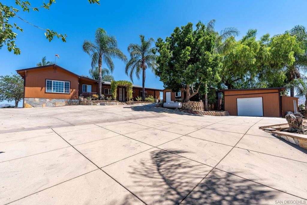 This gated tranquil hilltop estate offers a unique blend of privacy and convenience, expansive views, horse accommodations and functional amenities. You can enjoy the morning sunrise and magnificent sunsets from the breathtaking 360-degree panoramic views. The main house features 3 bedrooms and 2 bathrooms with a spacious kitchen including a large peninsula that opens into the family living area. The grounds are surrounded by mature landscaping, multiple fruit trees and plants like oranges, guava, figs, plums, grapes, blackberries, bananas and artichokes. The outdoor wrap around patios are fully equipped with a grilling station and fire pit, offering the perfect spot to relax and gaze at the evening stars or to entertain friends and family. The additional outdoor space is designed for equestrian enthusiasts, and includes a mare motel, large stall, and a small arena. The property also includes a separate converted 1 bed 1 bath ADU / granny flat that can accommodate extended family or can provide additional rental income. A large pass-through garage is perfect for storage, an office or can be converted into a fifth bedroom. Plenty of parking is available with a carport and also additional room to store your RV, trailers and toys. Don't miss out on this peaceful hilltop gem.