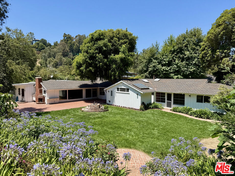 First time on the market in 62 years, this mostly flat, .623 acre property is nestled on its own private drive off of lower Mandeville Canyon. Quiet and serene, the mature lush landscaping surrounds this traditional ranch home and creates a compound-worthy estate. Grandfathered setbacks offer incredible entitlements and the existing home allows easy financing for added construction. Renovate, rebuild, or add to this incredible property. With parking for multiple cars, and the land to expand, this property is ready to be built back into a dream estate. Updated survey is available upon request. This is a rare opportunity for an owner / builder or developer. Easy to see existing vacant home.