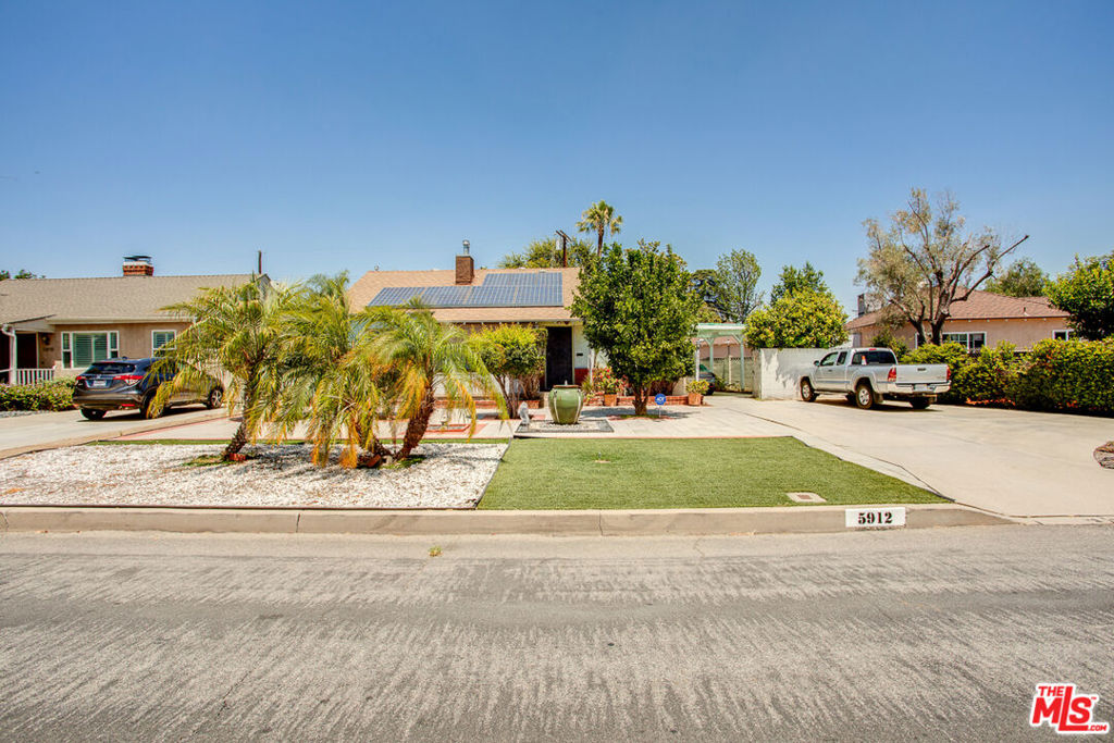 Welcome to Your Starter Dream Home! Nestled in the heart of Valley Village, Los Angeles, CA, this beautifully maintained home features 3 bedrooms, 2 bathrooms, and a 2-car garage with an opportunity to convert the garage into an ADU for additional living space or rental income. The property offers 4 additional parking spaces on the driveway and in front of the house. Conveniently located near cafes, restaurants, supermarkets, and parks. Easy access to major freeways and film studios. Interior Highlights onto the cozy front porch sitting area, and enter a spacious living room featuring a fireplace and an open floor plan leading into the kitchen. The entire home is equipped with central air conditioning, plus an extra wall-mounted unit in the master bedroom. Solar panels were installed in 2014. The current lease payment is $60.64/month, and the new owner has the option to purchase the system at the end of the lease term in 2031 (5 years remaining). Over the years, the owner has made thoughtful improvements, including: New carpet (under hardwood flooring), Water pipe replacement (around 2015)Replacement of gas lines and wastewater pipes (around 2017), Upgraded front yard with artificial turf and brick paversa water-saving feature, most windows replaced with aluminum-framed units (around 2018)Private Living & Outdoor SpaceThe primary bedroom includes an en-suite bathroom for added privacy. A dedicated laundry room is located just behind the kitchen. Step out back to the covered patio, perfect for relaxing or entertaining guests.