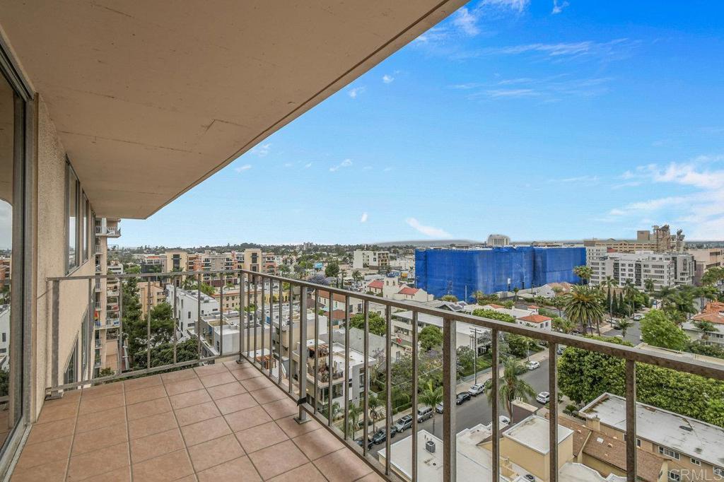 Welcome to this bright and spacious condo in the desirable Coral Tree complex, just minutes from Balboa Park and Hillcrest. Located on the 13th floor, this light-filled home showcases sweeping northeast-facing views of the mountains and city skyline. The open-concept living and dining area is accented by polished hardwood floors that bring warmth and character throughout. A retro-inspired kitchen with a breakfast bar adds to the charm. Both generously sized bedrooms offer stunning views, with the primary suite featuring a walk-in closet and en-suite bath. Additional conveniences include in-unit laundry and two assigned parking spaces. Coral Tree residents enjoy resort-style amenities including a pool, spa, tennis courts, and a clubhouse with a full kitchen, fireplace, and pool tables—perfect for entertaining or relaxing close to home. This home is ready for someone to make it their own!