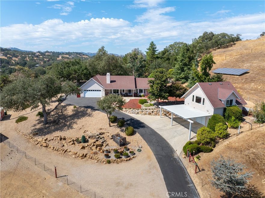 Welcome to this beautifully updated 3 bedroom, 2.5 bathroom home plus studio on ~ 5 gated acres, offering privacy, panoramic views and exceptional functionality. With 2140 sf of stylish living space in the main home and a 672 sf detached studio above the garage, this property is ideal for multi-generational living, guest space or rental income. Step inside to find luxury vinyl plank flooring throughout, leading you into a bright living room with vaulted ceilings, a cozy gas fireplace and large windows that perfectly frame the sweeping views. The custom kitchen is a showstopper with quartz countertops, soft-close cabinetry and pull-out drawers—perfect for both daily life and entertaining. The family room connects to the immaculate attached garage, which includes cabinets, a sink and epoxy floors for a clean, finished feel. On the opposite side of the home, you'll find two guest bedrooms and the generous primary suite, featuring vaulted ceilings, a walk-in closet and access to the back patio. The ensuite bathroom includes a dual sink vanity and a beautiful walk-in shower. Outside, enjoy peaceful evenings on the covered back porch, or explore the fully fenced property, complete with multiple sheds, animal shelters and a chicken coop—ideal for 4H projects or animal lovers. The detached 2-car garage includes a 672 sf studio apartment above with a spacious kitchenette, bathroom and large windows offering stunning views. Perfect for guests, extended family or potential rental income. Additional features include owned solar, newer roof, windows and interior paint. Privacy and space to roam, this property truly offers an elevated lifestyle with room to grow, create and enjoy country living without compromising modern comfort. Don’t let this one pass you by—schedule your private tour today! Review the Virtual Tour for additional photos and information.