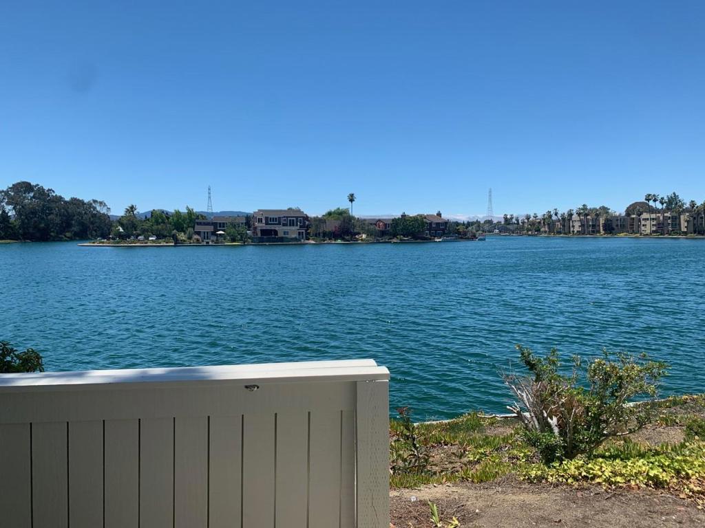 This is a one of a kind direct waterfront unit with views from Primary bedroom, Living Room, Dining Room and Kitchen. This 2 bedroom, 2 bathroom Townhouse has 1180 sq ft on 2 levels and an attached 2 car garage with laundry. Bamboo floor with carpet in bedrooms and tile in kitchen and bathrooms. Kitchen with solid surface counters and gas stove. Vaulted ceilings and a great open feel. 2 large bedrooms one upstairs and one downstairs. Primary bedroom has private waterview patio. Excellent schools. Close to Sea Cloud Park and Bay Trail. Close to shopping and many companies. Waterfront pool and hot tub and community beach make this place special. Do not miss this great place to come home to.